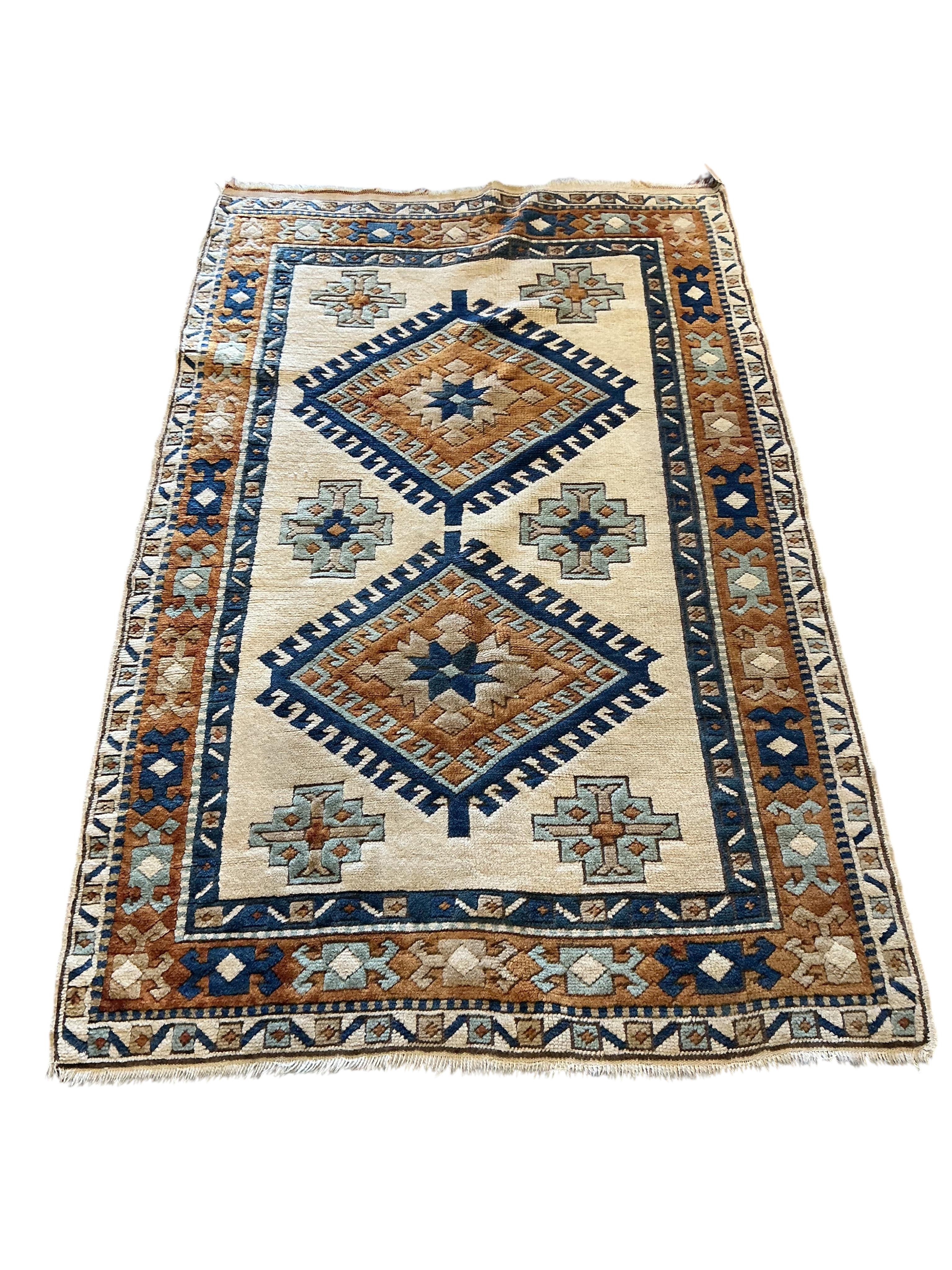 A Caucasian style ivory ground rug, 158 x 98cm